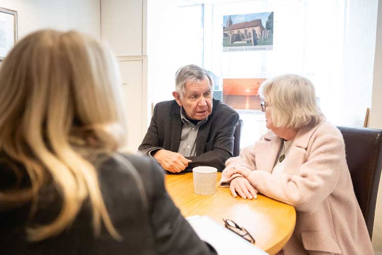 An elderly couple talking with an Orpington undertaker from Welham Jones Funerals & Memorials at their local funeral home in Orpington and Chelsfield