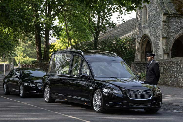Jaguar hearse and funeral limousine service in Chislehurst and Bromley outside a local church.
