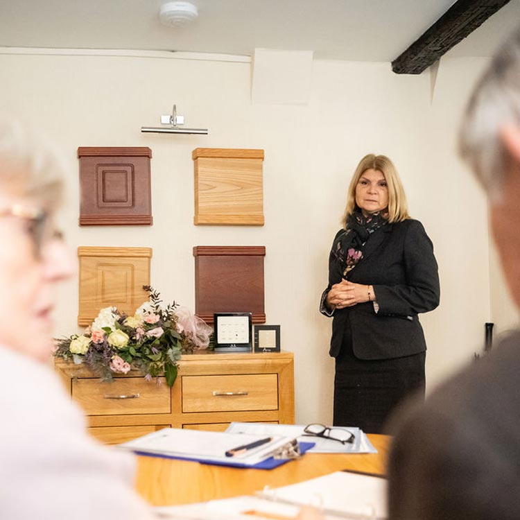Family viewing wood, wicker and cardboard coffin options with a funeral arranger in Borough Green.