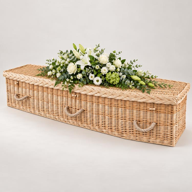 Handwoven wicker coffin with white flowers available in Borough Green.